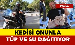 Motor tutkunu kedi onunla tüp ve su dağıtıyor