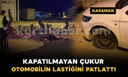 Karaman'da kazı çalışması yapılan yoldaki çukura düşen otomobilin lastiği patladı